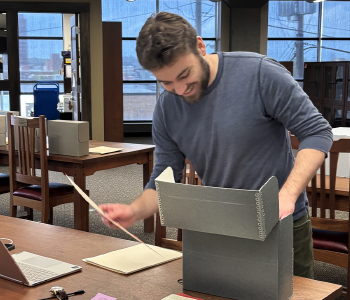 Researcher working with archival papers
